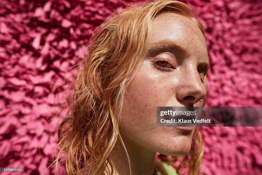 Close-up beautiful woman against textured wall