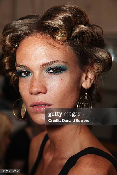 Model prepares backstage at the Luli Fama show during Mercedes-Benz Fashion Week Swim 2012 at The Raleigh on July 17, 2011 in Miami Beach, Florida.