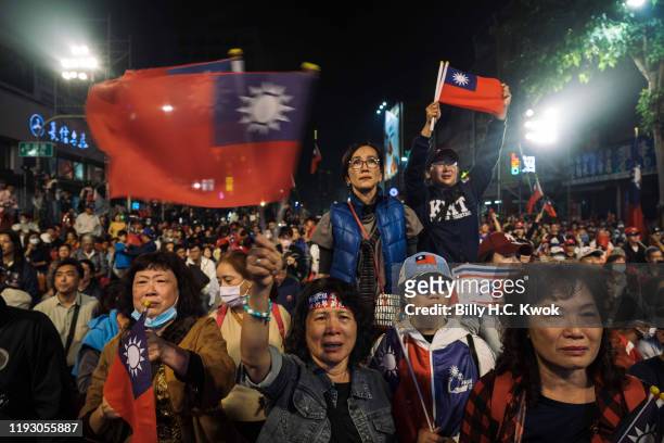 Supporters of Han Kuo-Yu, presidential candidate for Taiwan's main opposition Kuomintang party, react during a rally outside the campaign...