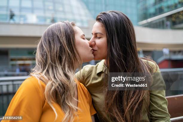 fffectionate lesbian couple kissing in the city, london, uk - lesbians kissing stock pictures, royalty-free photos & images