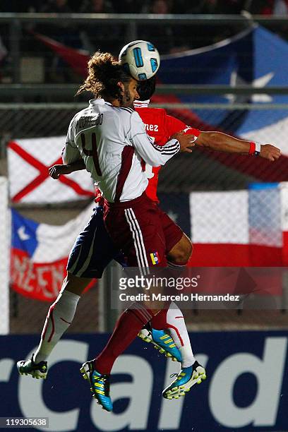 Luis Jiménez, from Chile, fights for the ball with Oswaldo Vizcarrondo, from Venezuela, during a quarter final match at Bicentenarium Stadium on July...