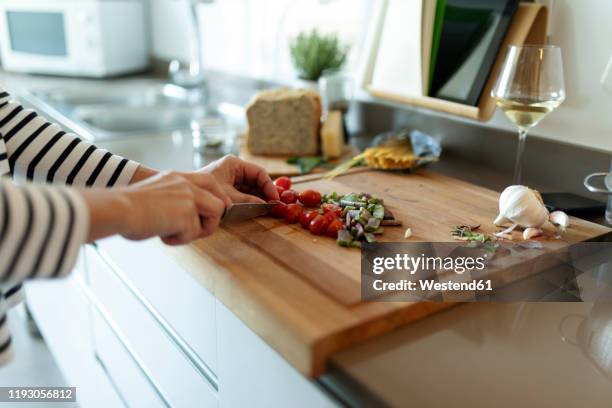 close-up of woman cooking in kitchen at home cutting vegetables - chopping stock pictures, royalty-free photos & images