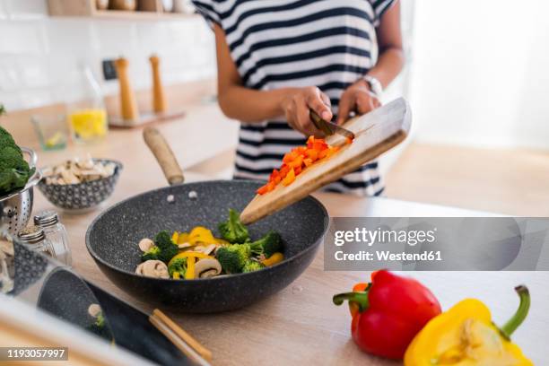 close-up of young woman with tablet cooking in kitchen at home - recipe bildbanksfoton och bilder