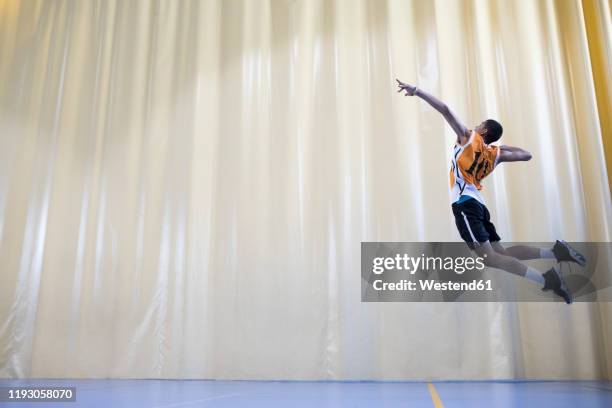 man jumping during a volleyball match to start a game - man wearing sports jersey stock pictures, royalty-free photos & images