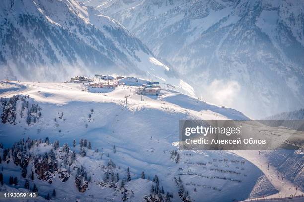 mayrhofen, austria cafes and restaurants on a stop on the penkenbahn lift on a background of snowy slopes - zillertal stock pictures, royalty-free photos & images