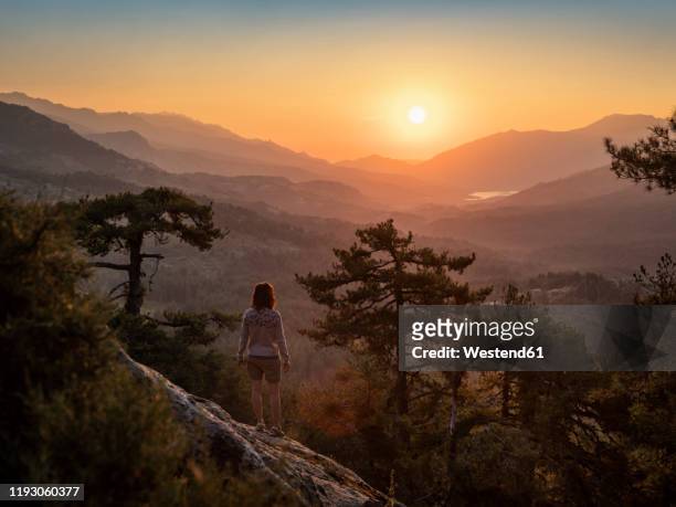 female hiker standing on viewpoint, albertacce, lac de calacuccia at sunrise, haute-corse, corsica, france - haute corse bildbanksfoton och bilder
