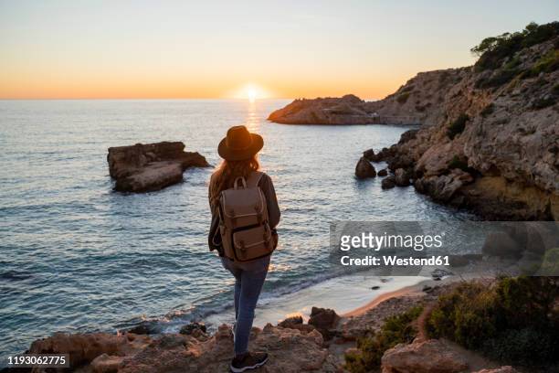 young woman on beach during sunset, ibiza - islas baleares fotografías e imágenes de stock