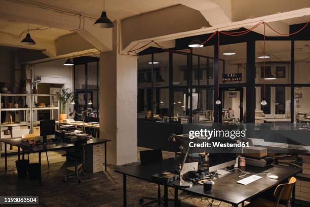 interior of a loft office - dusk dark stock-fotos und bilder