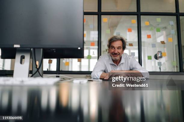 senior businessman in conference room in office - sticky-notes-covering-computer-monitor stock pictures, royalty-free photos & images
