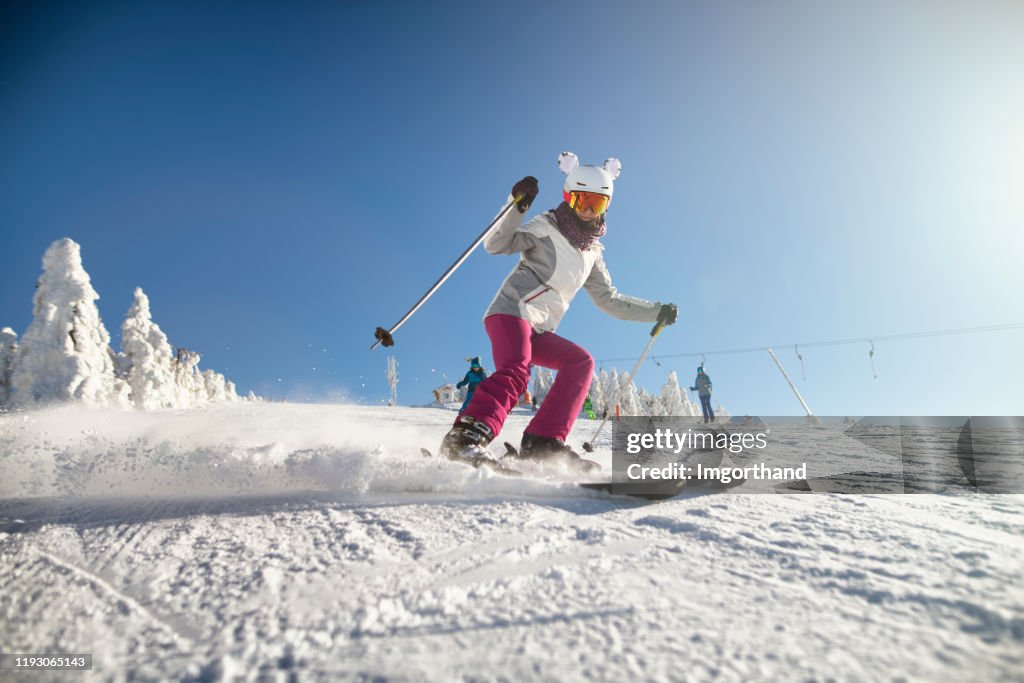 Teenage girl with family skiing on a beautiful winter day