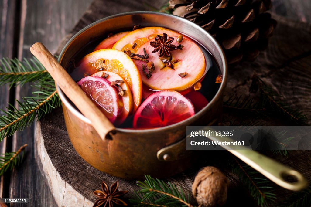 Mulled wine with oranges and cinnamon in a saucepan