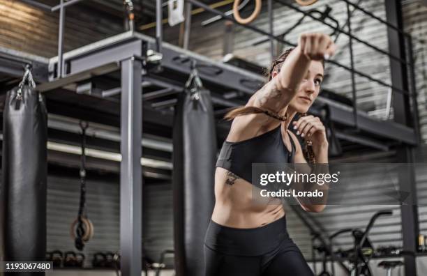 combattant féminin dans une gymnastique noire - luxury fitness center photos et images de collection