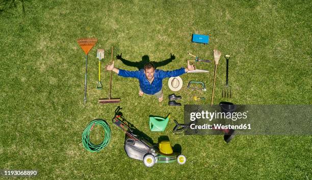 view from above of a gardener in standing on meadow with all the tools he need for take care of garden - lawnmowing stock pictures, royalty-free photos & images