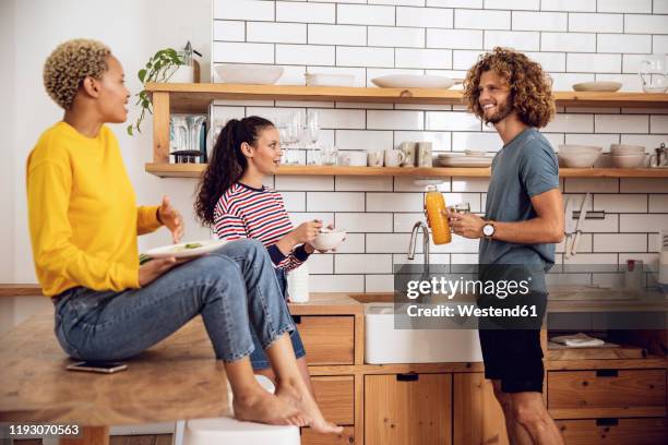 friends having breakfast in the kitchen at home - roommate stock-fotos und bilder