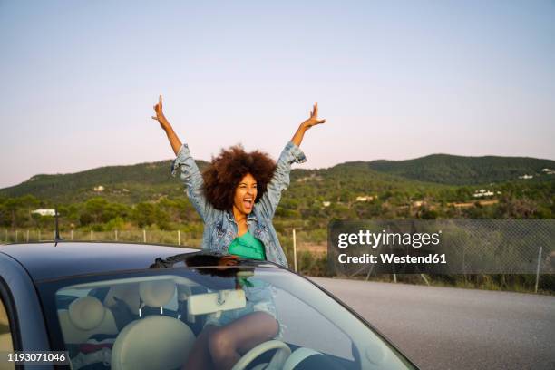 young woman during road trip with raised arms - isolated car people stock pictures, royalty-free photos & images