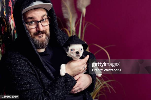 man holding his pug - irony stock-fotos und bilder