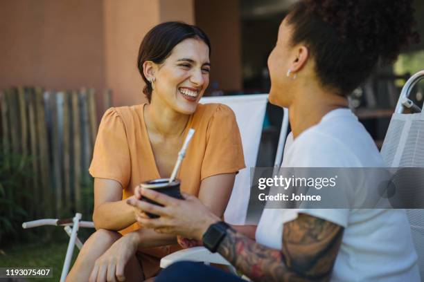 smiling friends sharing yerba mate - mate argentina stock pictures, royalty-free photos & images