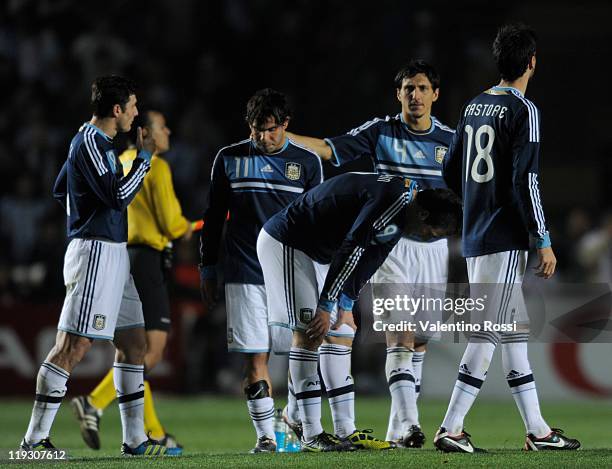 July 16: Argentina's players react after missing the penalty series against Uruguay during 2011 Copa America soccer match as part of quartes final at...