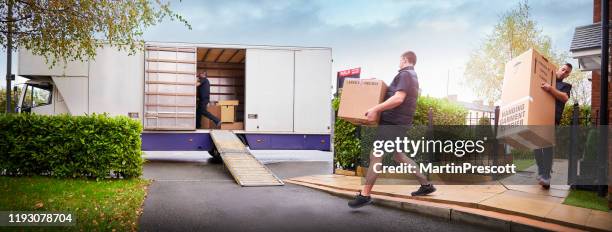 removal team loading removal truck - man boxes moving home stock pictures, royalty-free photos & images