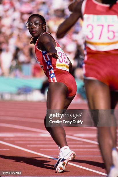 Diane Dixon of the United States hands over to team mate Denean Howard in Heat 1 of the Semi-Final of the Women's 4 × 400 metres relay event on 10th...