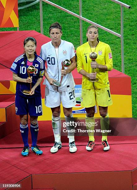 Homare Sawa of Japan receives the Best Player trophy, second place for Abby Wambach and third place for Hope Solo of USA, pictured after the FIFA...