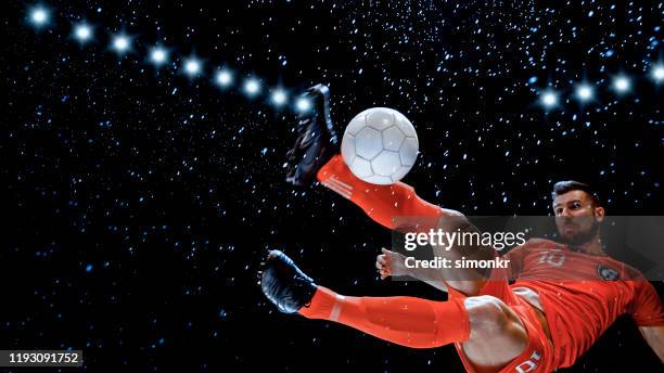 male football player kicking ball in air - bicycle kick stock pictures, royalty-free photos & images