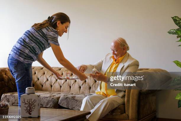 woman offering turkish coffee to her father - turkish coffee stock pictures, royalty-free photos & images