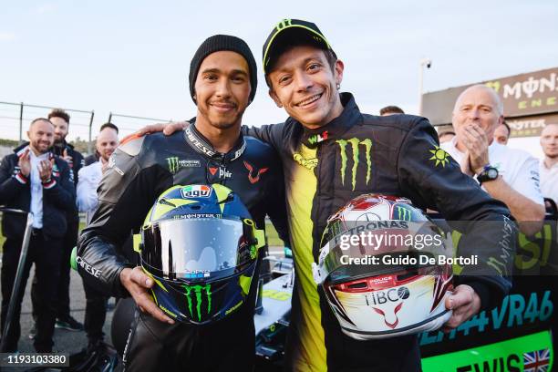 Lewis Hamilton of Great Britain and AMG Petronas F1 Team Mercedes and Valentino Rossi of Italy and Yamaha Factory Racing swapped their respective...