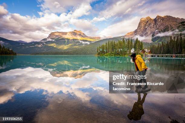 woman playing with reflections at emerald lake, yoho national park, canada - yoho national park bildbanksfoton och bilder