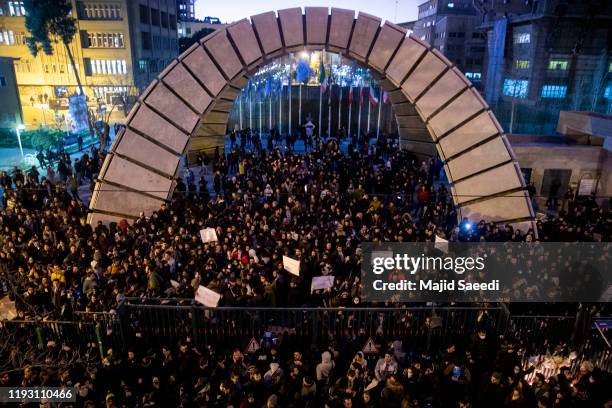 People gather for a candlelight vigil to remember the victims of the Ukraine plane crash, at the gate of Amri Kabir University where some of the...