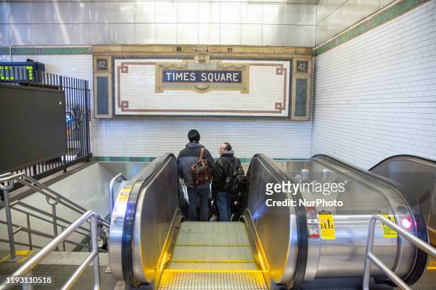 Times Square 42 St subway underground station in NYC with an old vintage inscription mosaic sign on the wall from tiles with symbols in terra cotta....