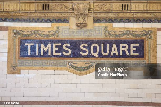 Times Square 42 St subway underground station in NYC with an old vintage inscription mosaic sign on the wall from tiles with symbols in terra cotta....