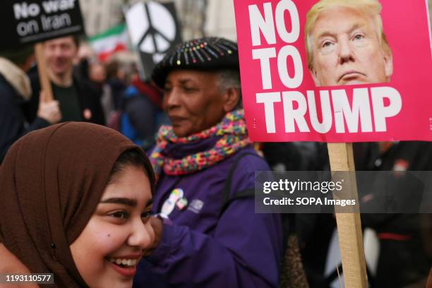 Woman holds an anti-Trump placard during the demonstration. Activists call for 'No War On Iran' at a demonstration and march organised by the Stop...