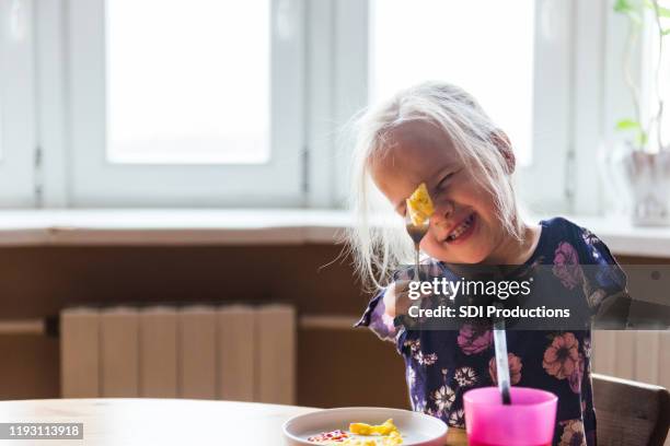 proud disabled girl eating breakfast - deformed hand stock pictures, royalty-free photos & images