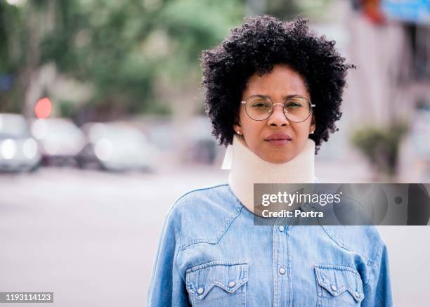 confident mid adult woman wearing neck brace - cervical collar stock pictures, royalty-free photos & images