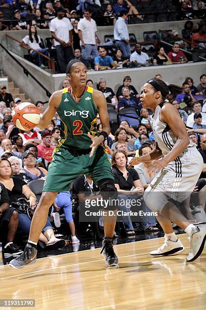 Swin Cash of the Seattle Storm handles the ball against Jia Perkins of the San Antonio Silver Stars at AT&T Center on July 14, 2011 in San Antonio,...