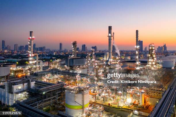 shot from drone of oil refinery plant ,petrochemical plant at dusk. - raffinerie stock-fotos und bilder