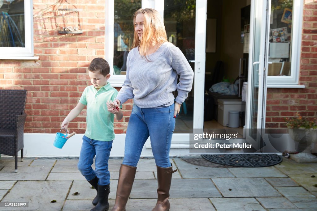 Mum And Son Doing Some Digging In The Garden High-Res Stock Photo ...
