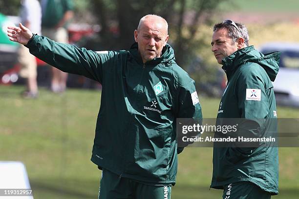 Thomas Schaaf , head coach of Bremen talks to Bremen's manager Klaus Allofs during the Werder Bremen training session on July 18, 2011 in...