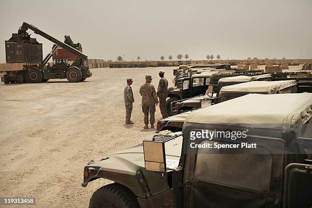 Military vehicles that have been cleaned and repaired are lined-up for return to the U.S. From Iraq at U.S. Military base Kalsu on July 18, 2011 in...