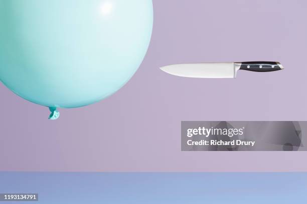 A kitchen knife chasing a  balloon