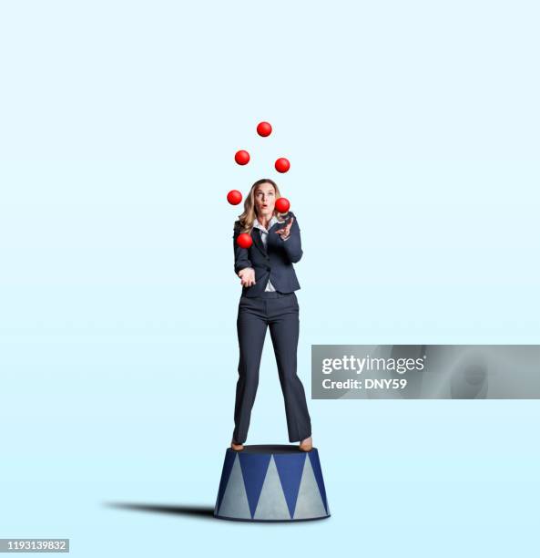 businesswoman juggling red balls - woman juggling stock pictures, royalty-free photos & images