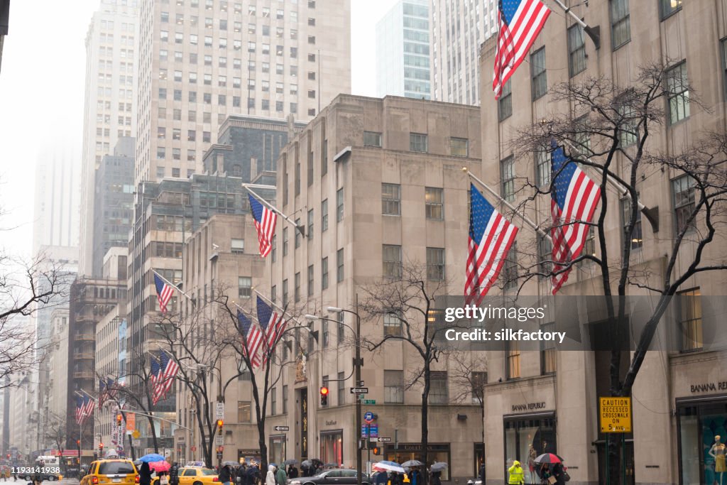 It is raining on an overcast winter day on 5th Avenue on Manhatten in New York City