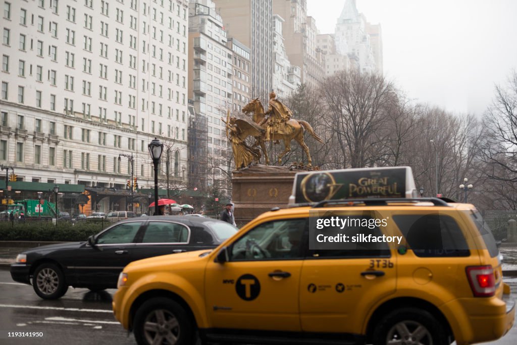 It is raining on an overcast winter day on 5th Avenue on Manhatten in New York City