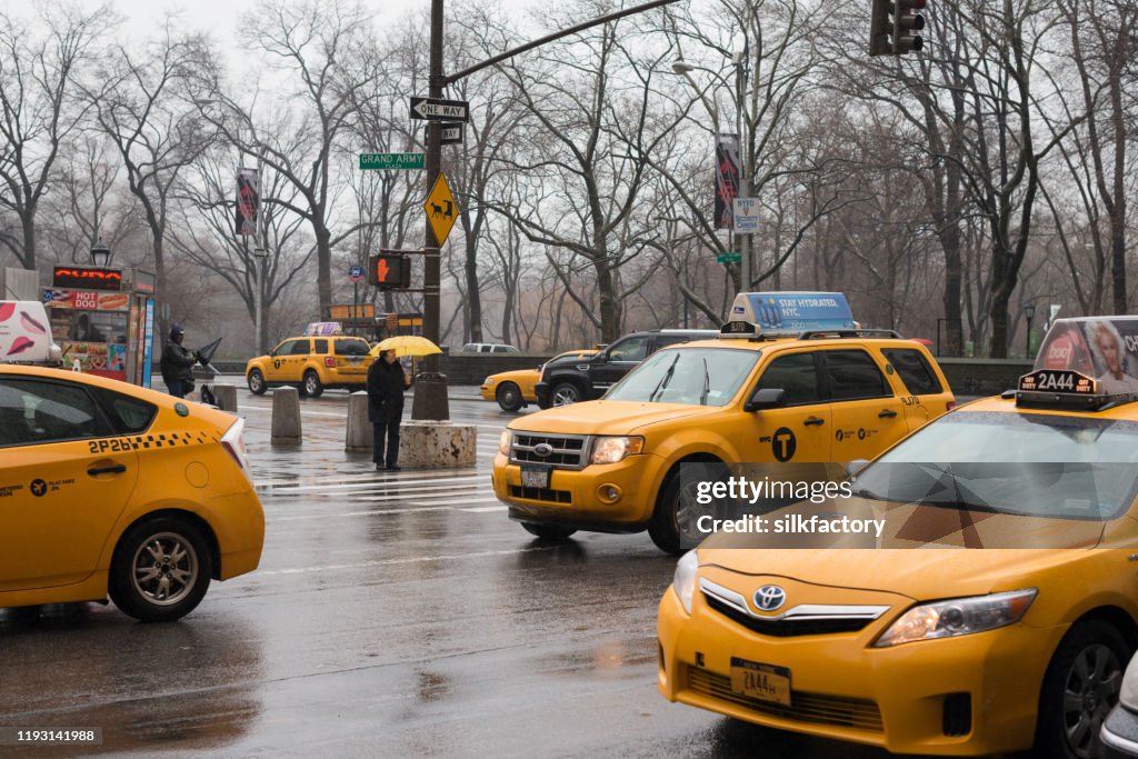 It is raining on an overcast winter day on 5th Avenue on Manhatten in New York City