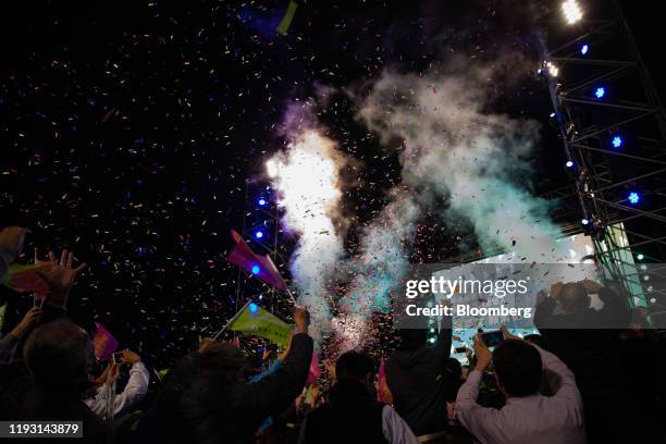 Attendees cheer after election results are announced during a Democratic Progressive Party rally with Taiwanese President Tsai Ing-wen in Taipei,...