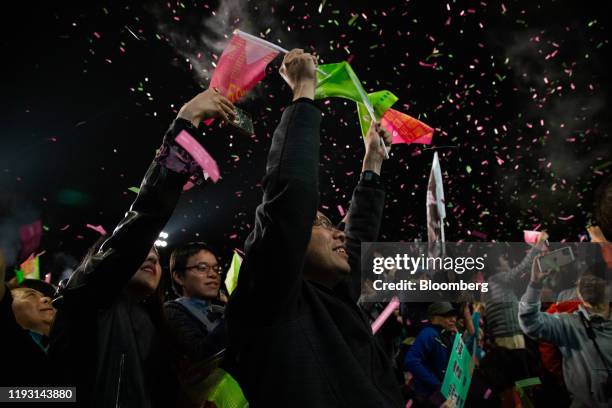 Attendees cheer after election results are announced during a Democratic Progressive Party rally with Taiwanese President Tsai Ing-wen in Taipei,...