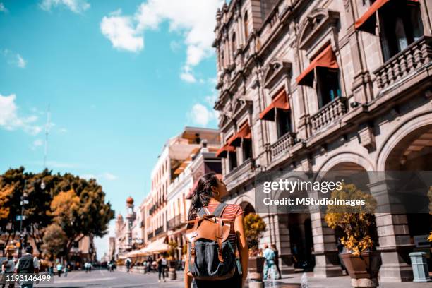 a happy tourist walking down the street - puebla mexico stock pictures, royalty-free photos & images
