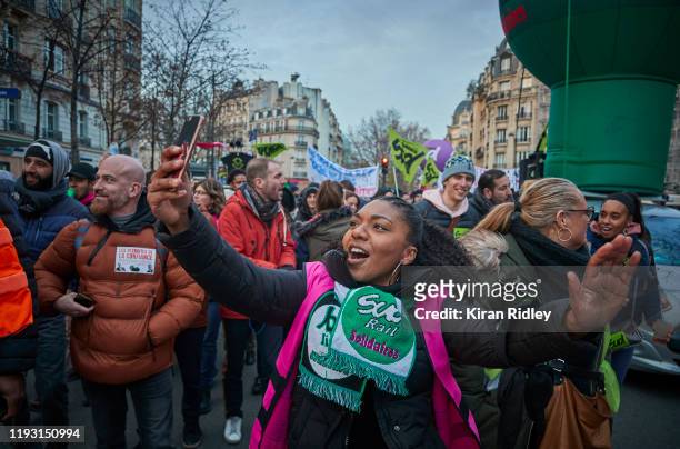 Protestor from the Sud Railway Union chants against President Macron during a rally near Place denfert Rochereau in Paris as thousands take to the...