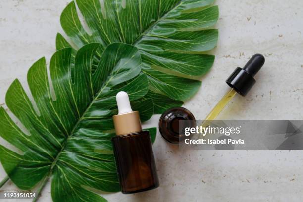 natural essential oils on marble background - hair products ストックフォトと画像